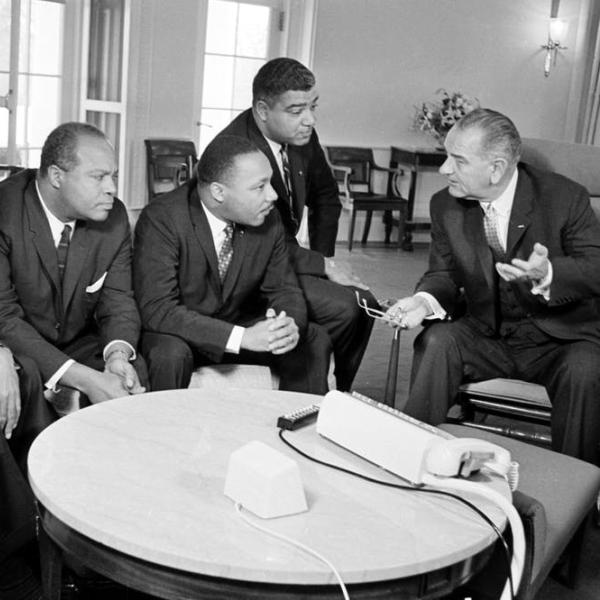 President Lyndon B. Johnson, right, talks with Martin Luther King Jr. and other civil rights leaders