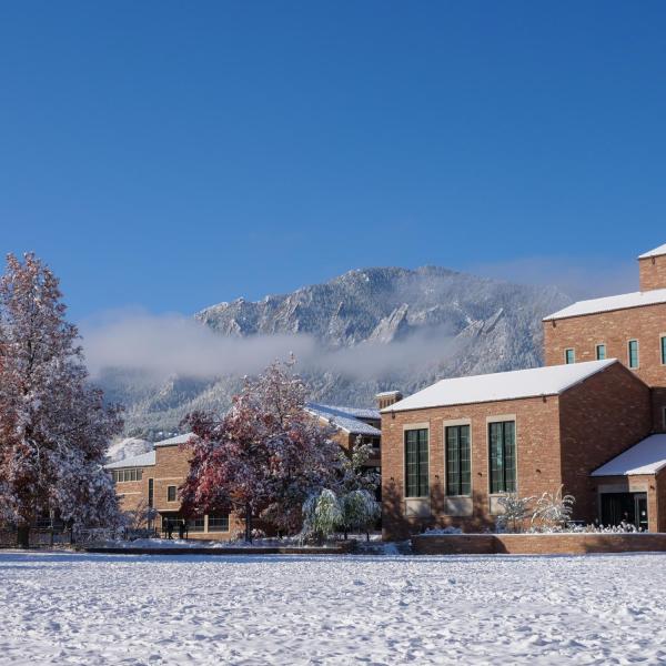 Building on campus on a snowy day with blue skies