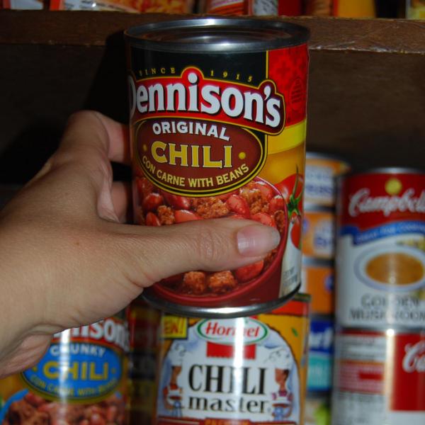 Woman reaches for canned good | Photo by Erin Kinney