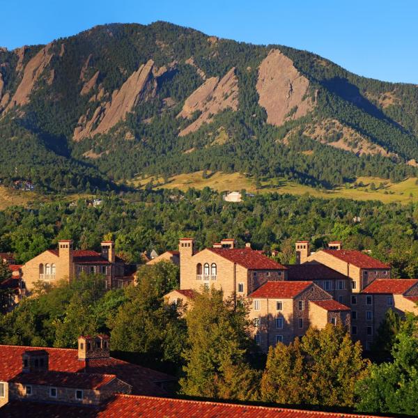 campus buildings with Flatirons in the background