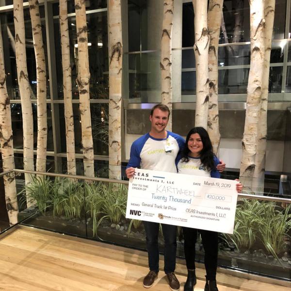 Winners of the general track pose with giant check
