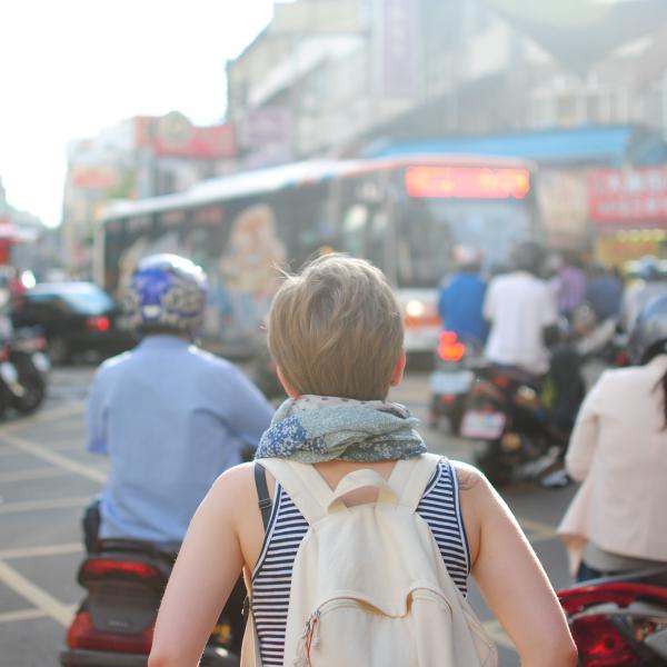 Woman explores busy streetway