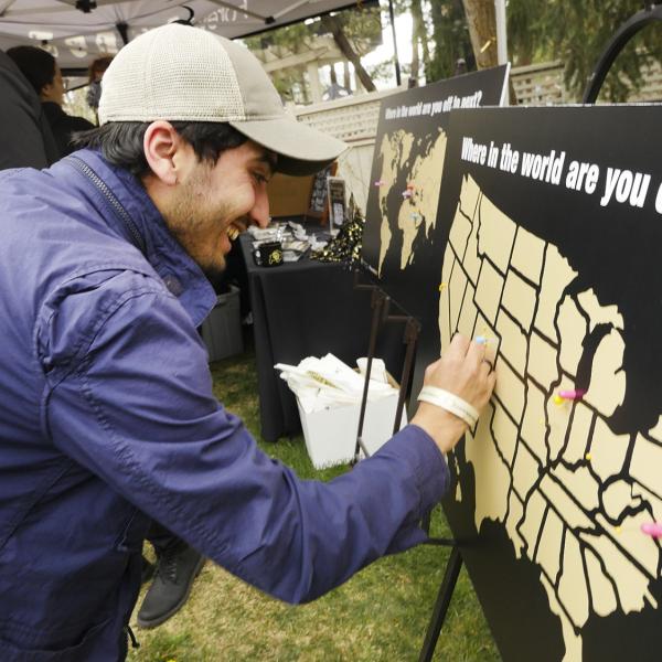 Graduate student scratching off a map at Grad Bash