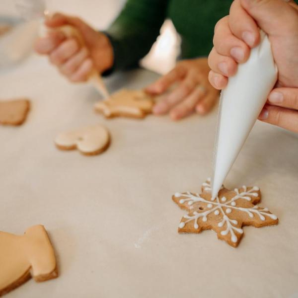people decorating holiday cookies