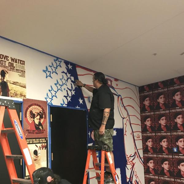 Gregg Deal working on new mural.
