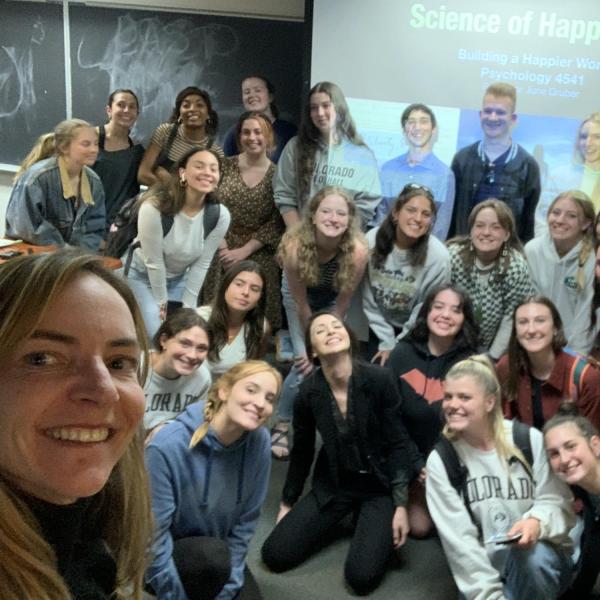 June Gruber takes a selfie with students in her Science of Happiness course