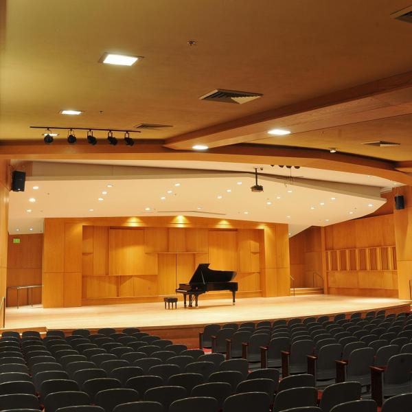 Piano on stage in an empty Grusin Music Hall