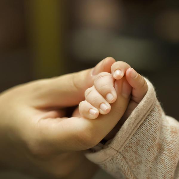 Mom holding her baby's hand