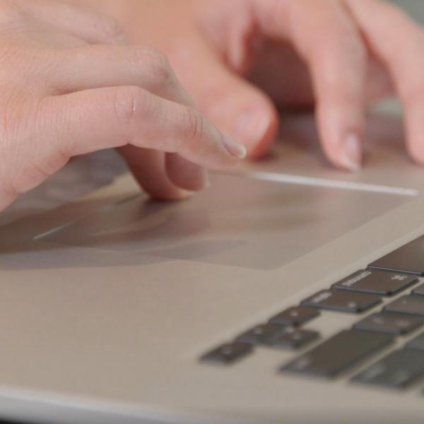 Hands typing on a laptop.