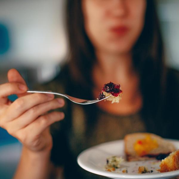 Person holding up a bite of food