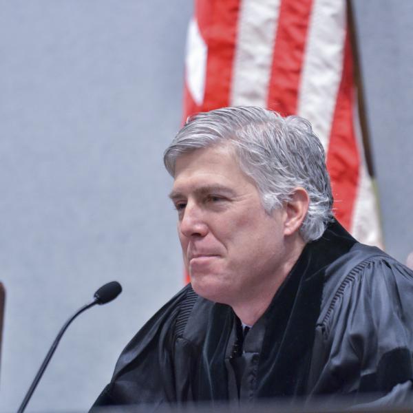 Neil Gorsuch sits at a courtroom bench. (Photo courtesy of Colorado Law.)