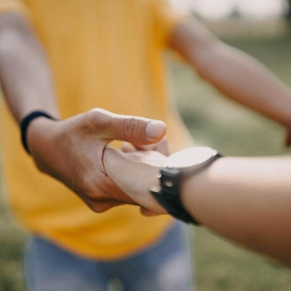 Two people holding hands