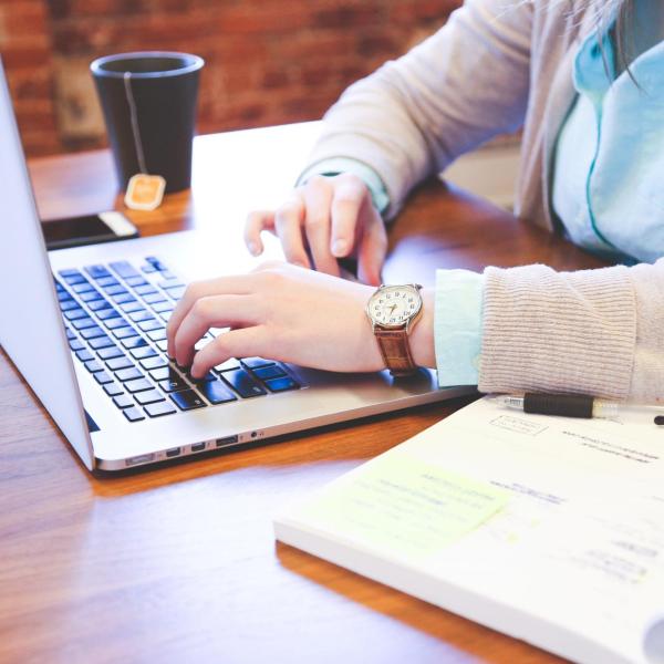 A woman sitting down working on a laptop