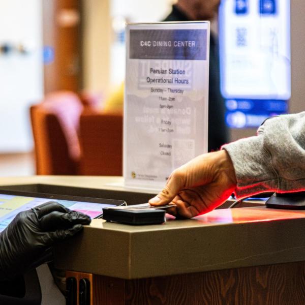 person swiping Buff OneCard