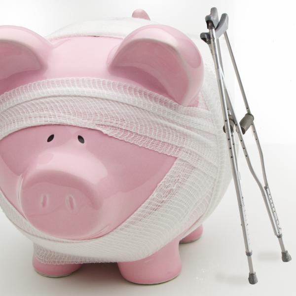 Injured piggy bank with crutches