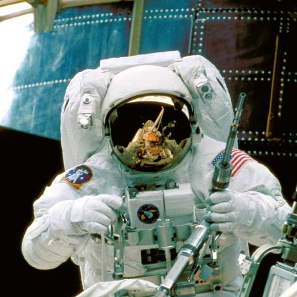 NASA astronaut services the Hubble Space Telescope from orbit.