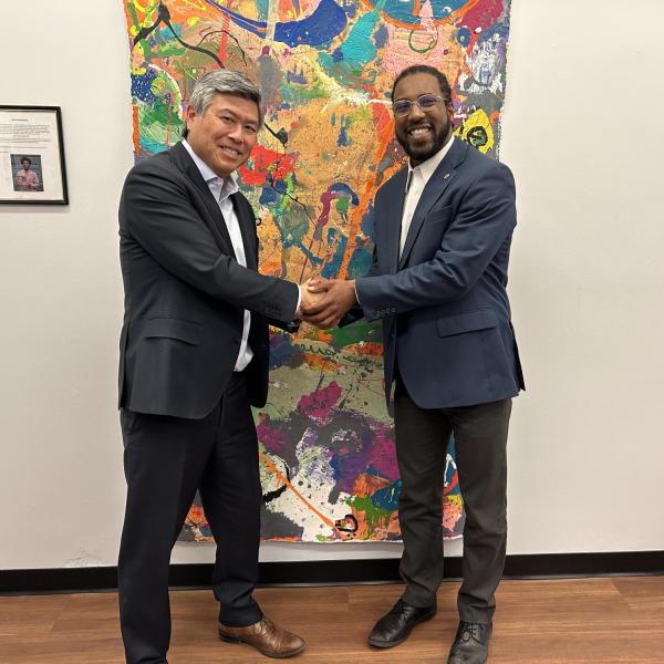 Daryl Maeda and artist DaMontá Madden in front of a painting.