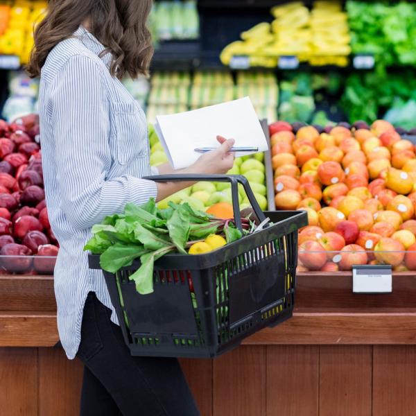 person shopping for fresh produce in a grocery store