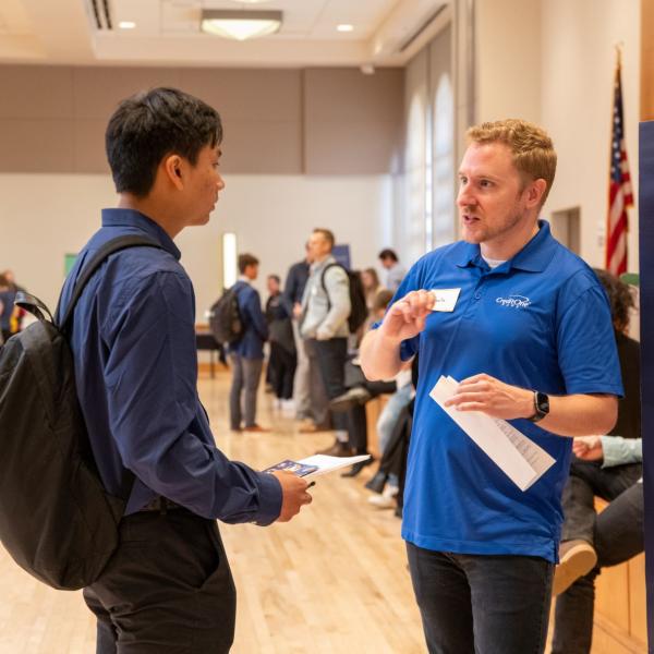 student speaking to an employer at a career fair