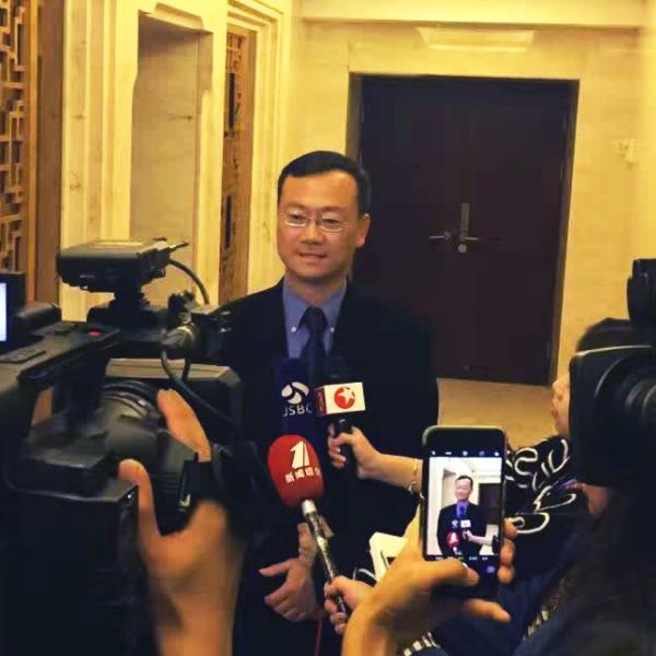 Professor John Zhai speaking with news media at the World IoT Exposition in China