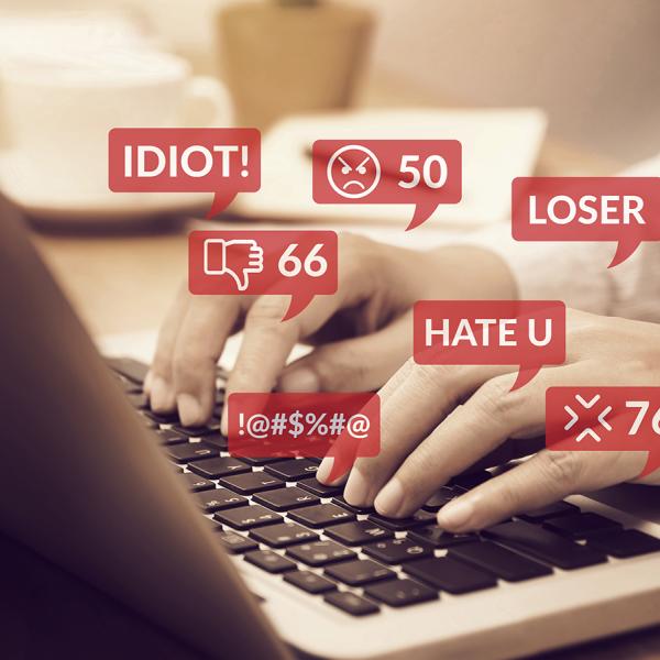 person typing hateful things on keyboard