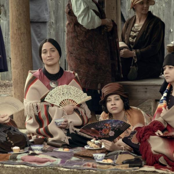 A photo showing several actors in the movie 'Killers of the Flower Moon'. The actors are portraying Indigenous women of the Osage Nation in the 1920s.