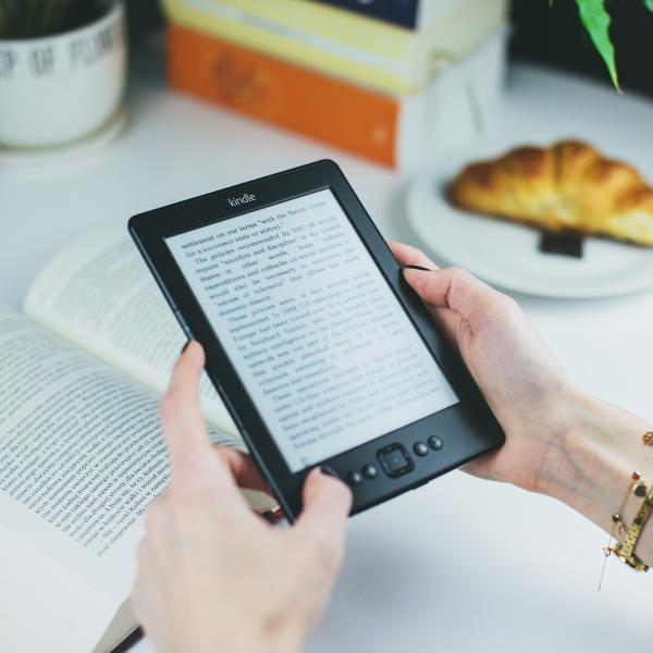 Woman reads book on Kindle e-reader