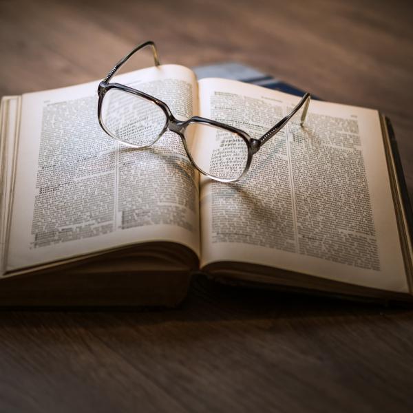 Old book with glasses on it