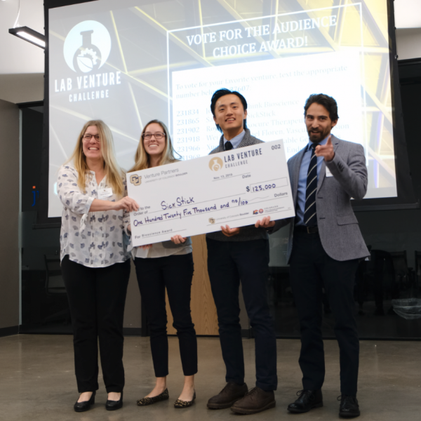 Winners hold a large Lab Venture Challenge check.