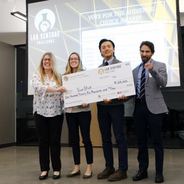 Winners hold a large Lab Venture Challenge check.