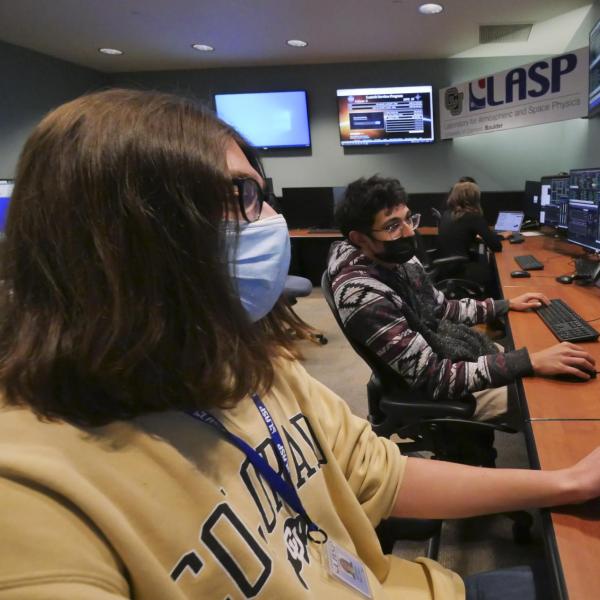 CU Boulder undergraduate students, left to right, Adrian Bryant and Rithik Gangopadhyay work in the mission operations center for IXPE.