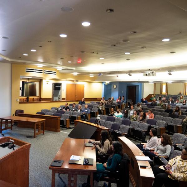 Audience members tune into a talk in Wolf Law