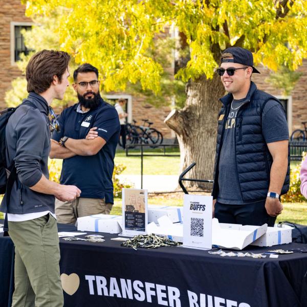transfer student visits a Transfer Buffs table on campus