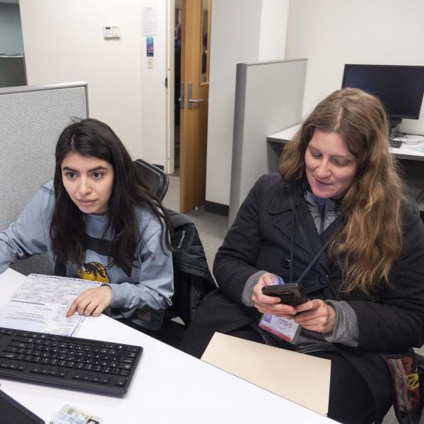 CU Boulder students helping someone with a tax return