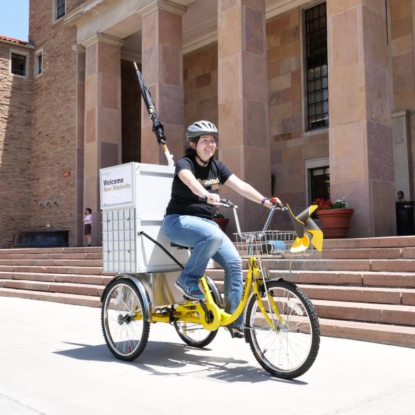 Woman on library bike in front of Norlin Library