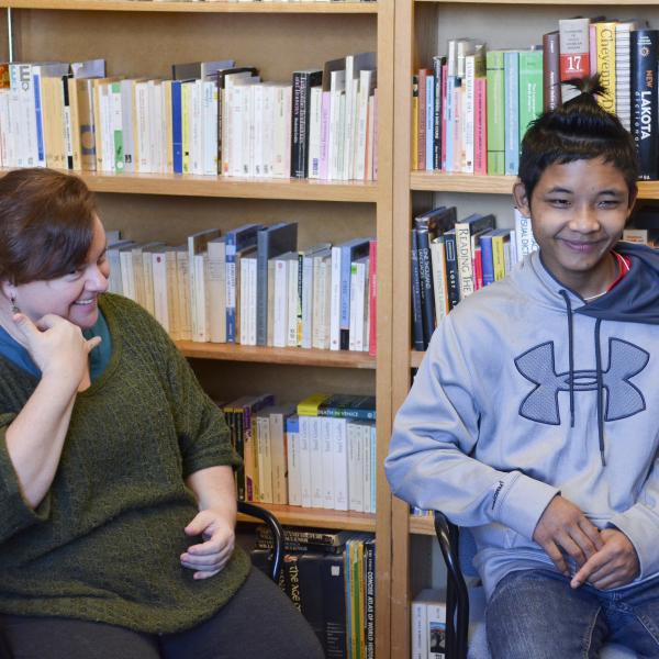 Pamela Wright signs with Taw, an 18 year old high school student in Boulder
