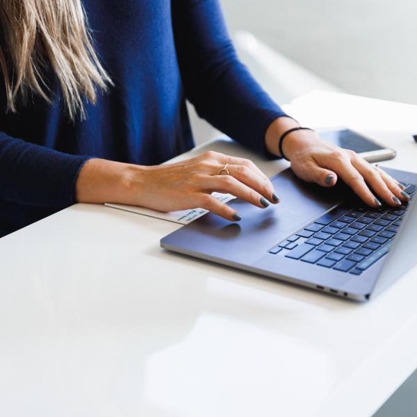 person typing on laptop