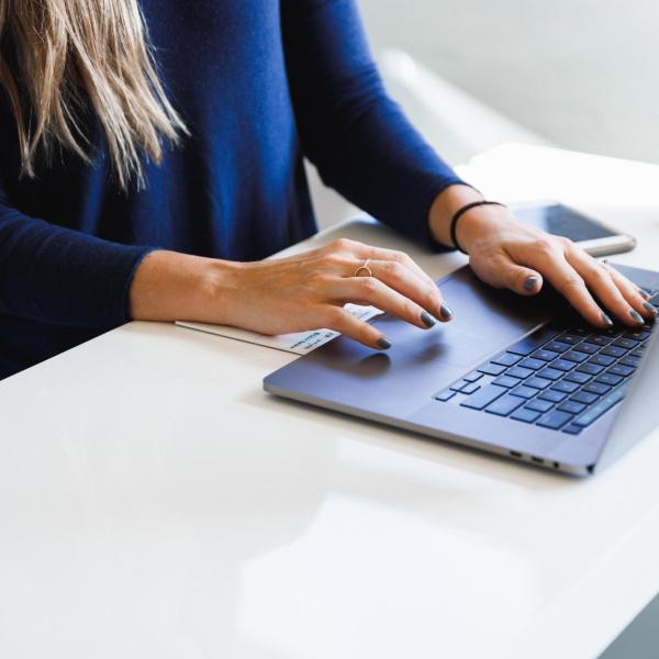 Person working on laptop at a desk