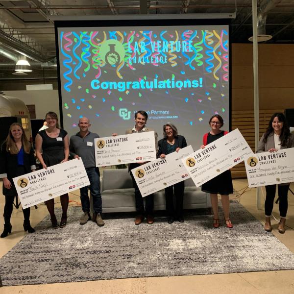 Lab Venture Challenge biosciences winners holding giant checks