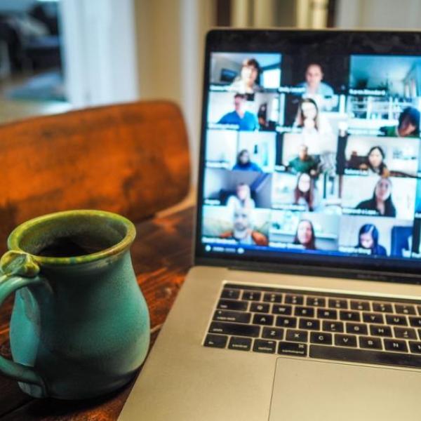 Coffee cup in front of computer screen.