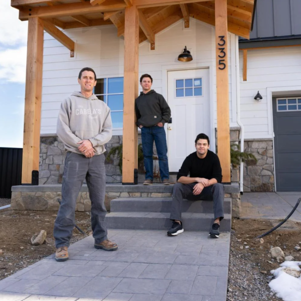Matt Morris, George Kurtz and Daniel Donado Quintero stand in front of Morris's new home