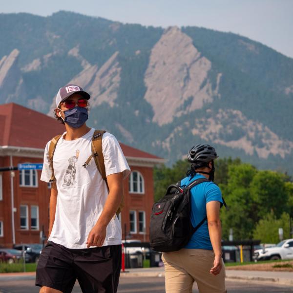 student wearing mask on campus outside