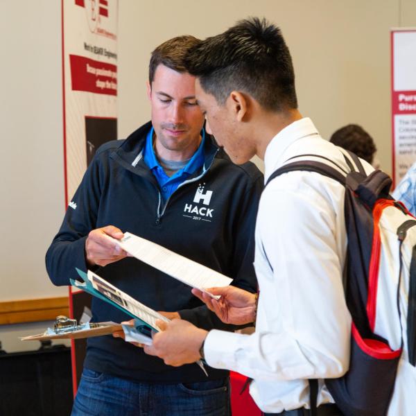 student speaking with someone at a career fair