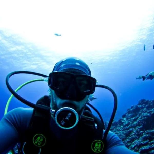 Mike Gil takes a selfie with a shark while scuba diving