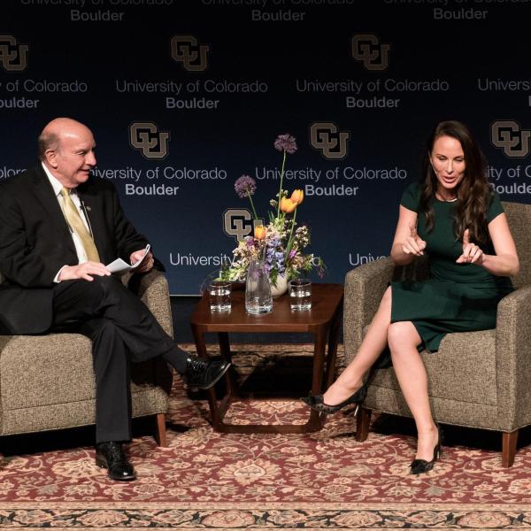 Molly Bloom interviews on stage with CU Boulder Chancellor Philip DiStefano at Macky Auditorium (Kira Vos)