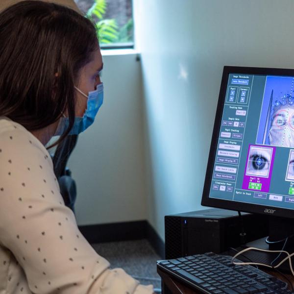 Graduate student Megan Caruso monitors data from an eye-tracking program that can follow a subject's attention as they learn or