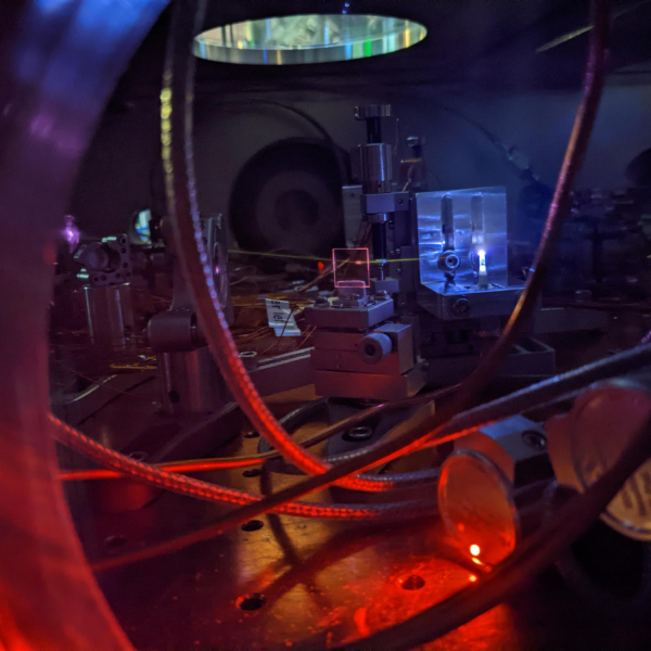 Photo of a chamber with tubes, crystals and laser light insight