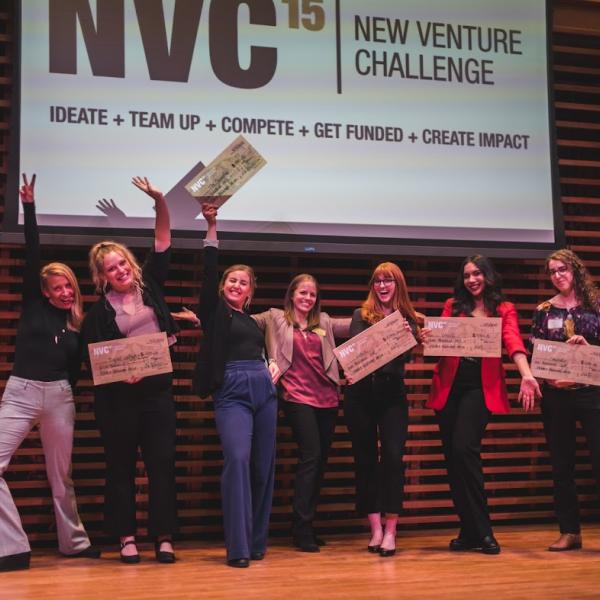 New Venture Challenge participants celebrate on stage on female founders night.