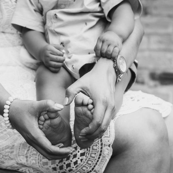 A mother holding a baby's feet
