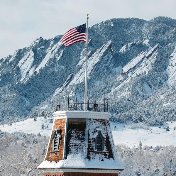 A snow-dusted Old Main.